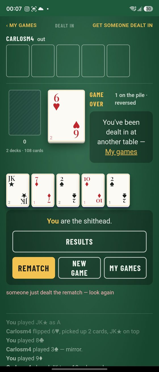 The felt at game over: the other player's cards up top, the pile, your table cards, the banner